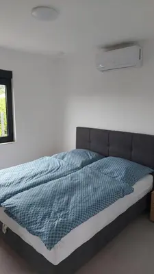 a bedroom with a bed with a blue blanket at Casa Aurelia in Gornji Štoj