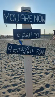 a sign in the sand on a beach at Casa Aurelia in Gornji Štoj