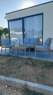 a group of benches and tables in front of a building at Casa Aurelia in Gornji Štoj