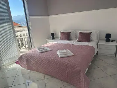 a bedroom with a bed with two towels on it at TIA Sveti Stefan in Budva