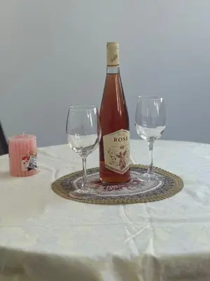 a bottle of wine and two wine glasses on a table at TIA Sveti Stefan in Budva