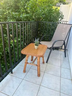 a wooden table and a chair on a patio at TIA Sveti Stefan in Budva