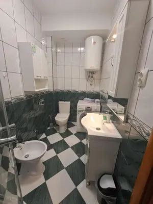 a bathroom with two sinks and two toilets at N&B Apartment Kotor in Kotor