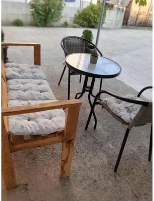 two chairs and a table and a table and a table and chairs at Riian Luxury Apartments in Ulcinj