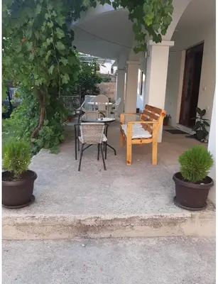 a patio with a table and a bench and a table and chairs at Riian Luxury Apartments in Ulcinj