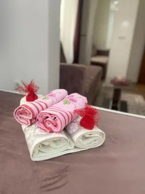 a pile of towels sitting on a table at Riian Luxury Apartments in Ulcinj