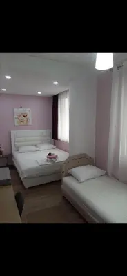 a bedroom with two beds and a couch in it at Riian Luxury Apartments in Ulcinj
