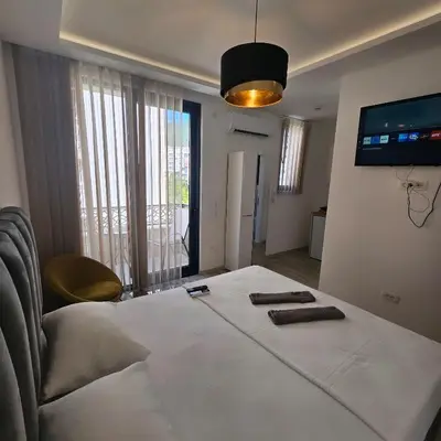 a bedroom with a bed with two towels on it at La Vida Apartments in Babalonija
