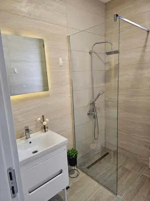 a bathroom with a sink and a shower at La Vida Apartments in Babalonija