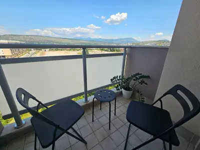 two chairs and a table on a balcony with a view at White Sensation in Podgorica