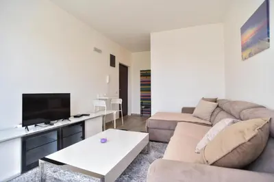 a living room with a couch and a tv at Petra Apartment in Ulcinj