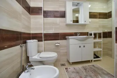 a bathroom with a toilet and a sink and a mirror at Petra Apartment in Ulcinj