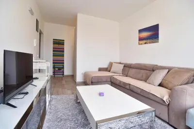 a living room with a couch and a tv at Petra Apartment in Ulcinj