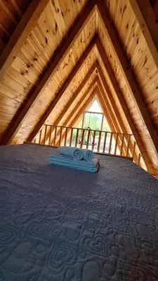 a attic room with a roof with a window at Bella Home in Rap
