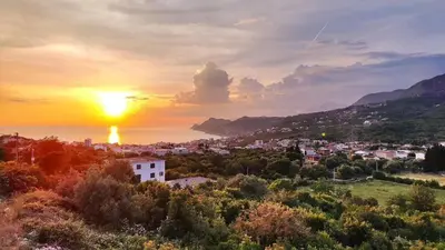 a view of a city with the sunset in the background at Montenegro Tower in Pečurice