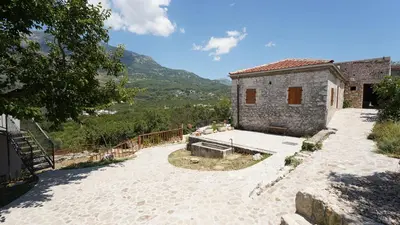 a stone house with a view of a mountain at Montenegro Tower in Pečurice