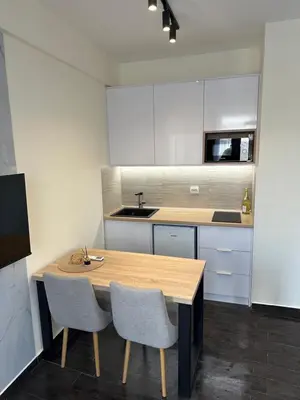 a kitchen with a wooden table and two chairs at Apartment Angela in Donji Štoj