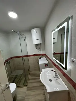 a bathroom with a sink and a shower and a toilet at Apartment Angela in Donji Štoj