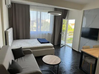 a room with a bed and a couch and a tv at Apartment Angela in Donji Štoj