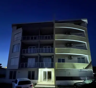 a building with a car parked in front of it at Apartment Angela in Donji Štoj
