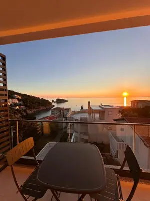 a balcony with a table and chairs and a sunset at Residence Vongola in Bar