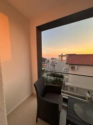 a balcony with a chair and a view of a city at Residence Vongola in Bar