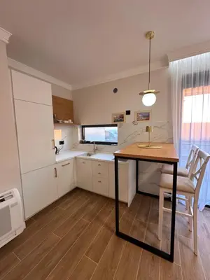 a kitchen with a table and a dining room at Residence Vongola in Bar