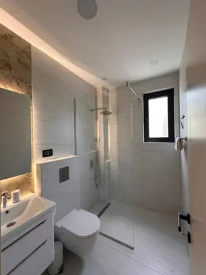 a bathroom with a shower and a toilet and a sink at Residence Vongola in Bar