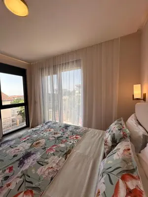 a bedroom with a bed and a large window at Residence Vongola in Bar