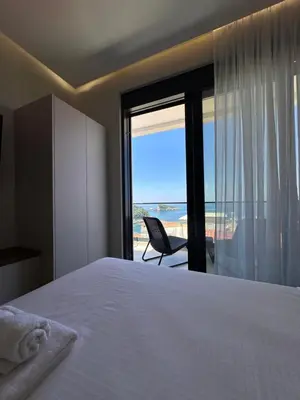 a bedroom with a bed and a view of the ocean at Residence Vongola in Bar