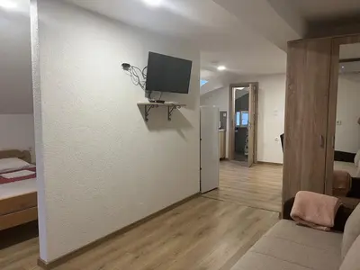 a living room with a tv on a wall at Sea in Bar