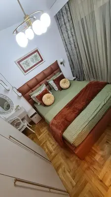 a bedroom with a large bed with a couch at Apartment Kata in Cetinje