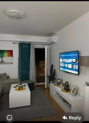 a living room with a couch and a flat screen tv at Marelica Apartman in Bar