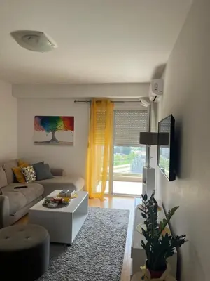 a living room with a couch and a table at Marelica Apartman in Bar