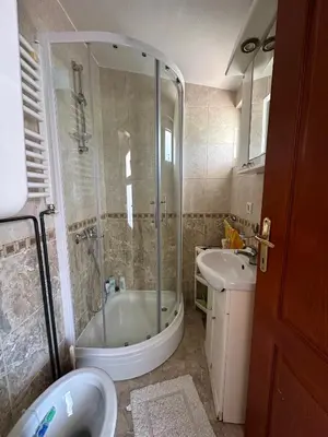 a bathroom with a shower and a tub and a sink at Apartment Maša in Radanovići