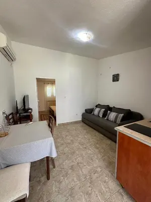 a living room with a couch and a table at Apartment Maša in Radanovići