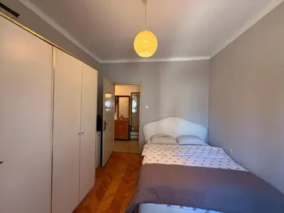 a small bedroom with a bed and a light at Center Square in Podgorica