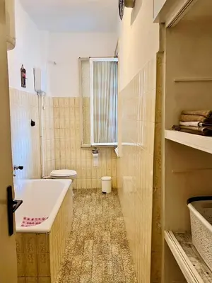 a bathroom with a sink and a toilet and a window at Center Square in Podgorica