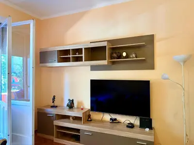 a living room with a flat screen tv on a wall at Center Square in Podgorica