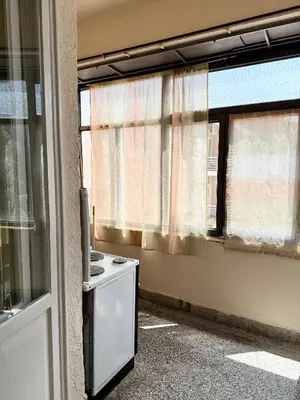 an empty room with a kitchen with a window at Center Square in Podgorica