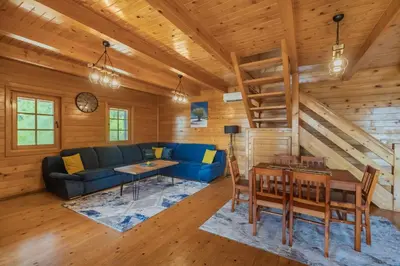 a living room with a blue couch and a wooden ceiling at Panora Oliva in Rap