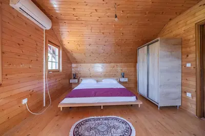 a bedroom with a bed in a wooden room at Panora Oliva in Rap