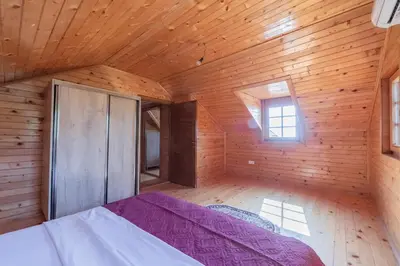a bedroom with a bed in a wooden room at Panora Oliva in Rap