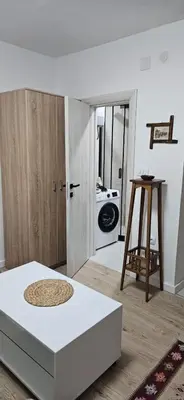 a room with a bed and a door with a washing machine at Apartman Olivera in Sutomore