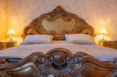 a large bed with a large headboard in a bedroom at VILLA-BAROCCO Sveti-Stefan & Private Garden in Sveti Stefan