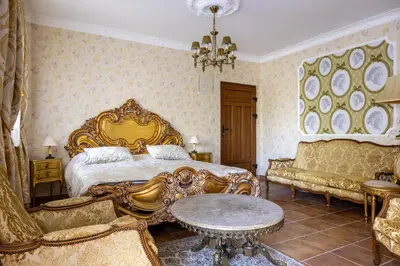 a bedroom with a bed and a table and chairs at VILLA-BAROCCO Sveti-Stefan & Private Garden in Sveti Stefan