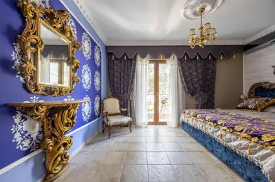 a bedroom with blue walls and a mirror at VILLA-BAROCCO Sveti-Stefan & Private Garden in Sveti Stefan