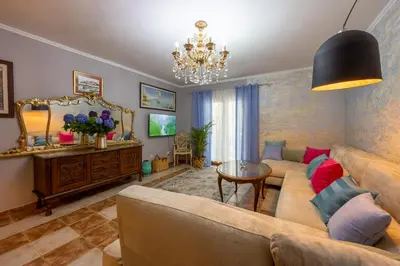 a living room with a couch and a table at VILLA-BAROCCO Sveti-Stefan & Private Garden in Sveti Stefan
