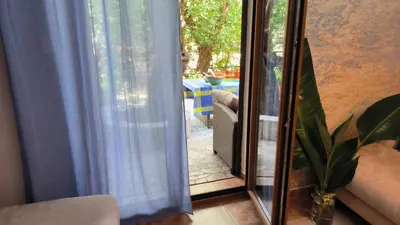 a sliding glass door with a view of a patio at VILLA-BAROCCO Sveti-Stefan & Private Garden in Sveti Stefan