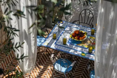 a table with a bowl of fruit and a plate of food at VILLA-BAROCCO Sveti-Stefan & Private Garden in Sveti Stefan